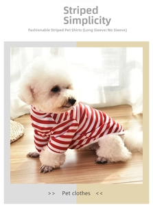 Detail of soft red and white striped pet vest for small dogs on wooden floor