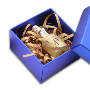 Royal blue gift box with golden raffia paper shreds filler for premium packaging