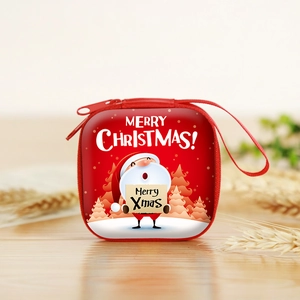 Close-up of a festive red square coin purse featuring a Santa Claus design on a wooden desk