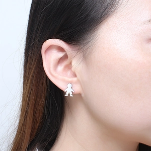 Minimalist silver stainless steel stud earring with a cartoon boy silhouette on model