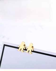 Close-up of golden cartoon boy silhouettes stainless steel studs on white display card
