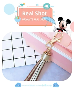 Detail of premium champagne gold PU leather tassel keychain with a metal lobster clasp