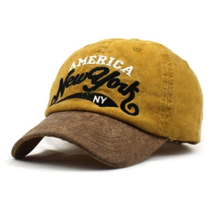 Detail of vintage baseball cap with yellow crown, brown brim and America embroidery