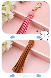Detail of pink and brown leather tassel keychains with golden metal lobster clasps