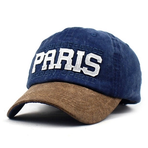 Close-up of embroidered PARIS text on vintage washed cotton navy and brown baseball cap