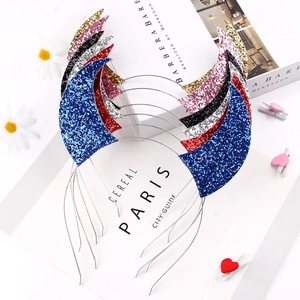 Close-up of glittery devil horn headbands in various colors on a stylish background