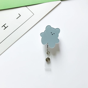 Detail of blue acrylic bear retractable badge holder with metal clip and snap strap