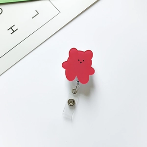 Detail of red bear acrylic retractable badge holder with metal snap and clear strap