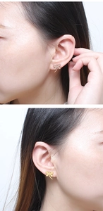 Detail view of dragonfly stud earrings in gold and rose gold finish worn on ears