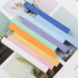 Artistic layout of colorful soft pastel chalk sticks for painting on illustrated paper