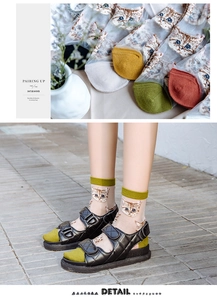 Detail showing cartoon cat prints and color-block toes on sheer lace socks for women