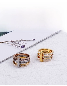 Detailed view of 18k gold plated triple-layered rings with pavé crystal settings