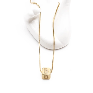 Gold box chain necklace with micro-paved zircon square initial B pendant on white hand mold