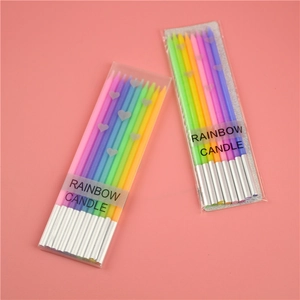 Detailed view of rainbow gradient thin candles in transparent boxes with silver accents