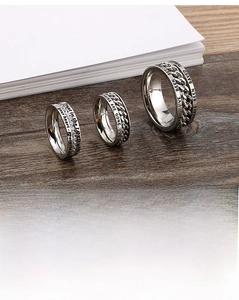 Macro detail of titanium steel chain rings featuring zircon stones and Bible engravings