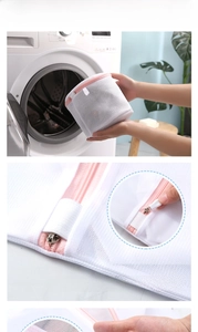 Macro shot of white mesh laundry bag with pink trim, hidden zipper, and cylinder support frame