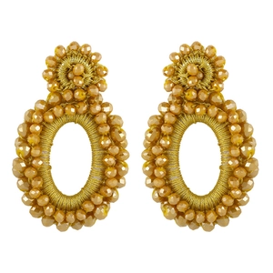 Macro shot of gold bohemian seed bead earrings featuring handmade woven craftsmanship