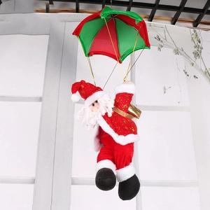 Detail of hanging Santa Claus with red and green parachute and golden gift bag ornament