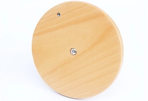 Macro detail of natural beech wood circular base showing grain and screw hardware