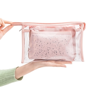 Close-up of waterproof transparent PVC makeup bag with pink handle and sequin pouch insert