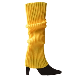 Macro shot of bright yellow knitted leg warmer styled with a black stiletto boot