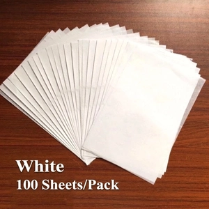 Macro detail of 100 sheets of white tissue wrapping paper fanned out on wood