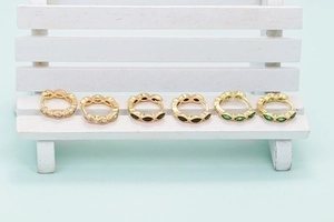 Gold huggie hoop earrings with marquise-cut white, black and green crystals
