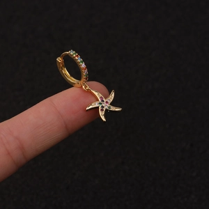 Close-up of a gold-toned hoop earring with a colorful rhinestone starfish pendant
