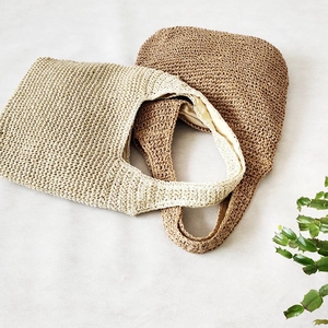 Fashionable woven straw tote bags in beige and coffee colors for women on a white background