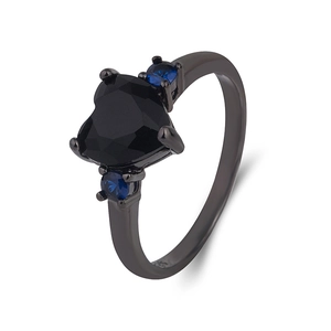 Black heart-shaped gemstone ring with blue side stones and gun-black finish