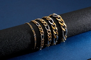 Detail showing various thicknesses of gold and silver 3:1 NK steel link chains on a display
