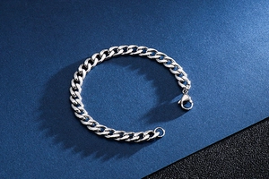 Detailed view of silver Cuban link bracelet with lobster clasp on professional background
