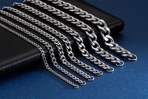 Detail showing seven widths of silver Cuban link chains in polished stainless steel