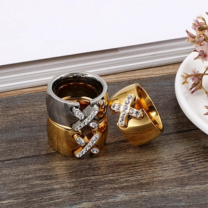 Classic stainless steel anchor ring set with white cubic zirconia on dark wood background