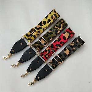 Detailed view of adjustable leopard print bag straps with leather ends and gold hardware