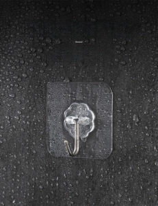 Waterproof transparent adhesive hook on wet gray wall for bathroom and kitchen use