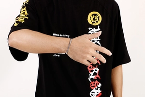 Silver cuban link chain bracelet displayed on a male wrist with black casual t-shirt