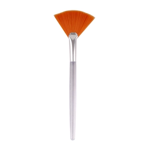 Fan brush with orange bristles for facial masks and acid peel treatments