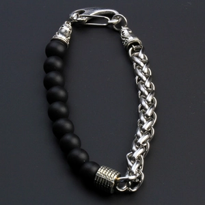 Detail of men's bracelet with black matte beads and braided steel chain with lobster clasp