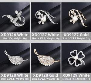 Detail showcasing variety of pearl and rhinestone floral brooches in gold and silver
