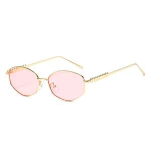 Fashionable oval champagne gold metal sunglasses with light pink lenses for outdoor style