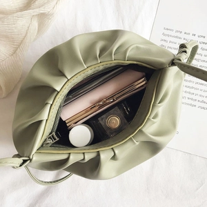 Green pleated cloud crossbody bag with large interior storage and zipper pocket