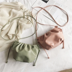 Detail of ruched cloud bags in bean green and nude pink colors with thin straps