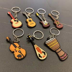 Detailed set of 7 colorful PVC musical instrument keychains including guitar and violin