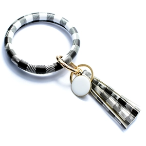Detail of checkered leather keychain bracelet with tassel and gold metal hardware