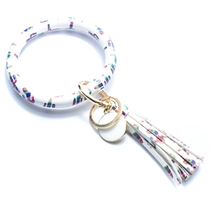 Detail of white PU leather bracelet keychain with colorful cactus print and tassel