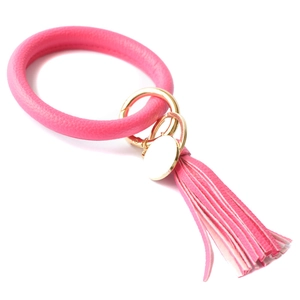 Detailed view of a pink PU leather wristlet keychain with golden metal ring and tassel