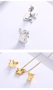 Detailed view of silver and gold stainless steel cat earrings and necklace jewelry set