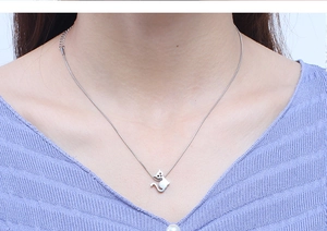 Close-up of silver cat pendant necklace on model with snake chain and extender