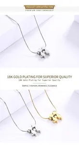 Detail view of 18K gold plated steel couple silhouette pendants on snake chains